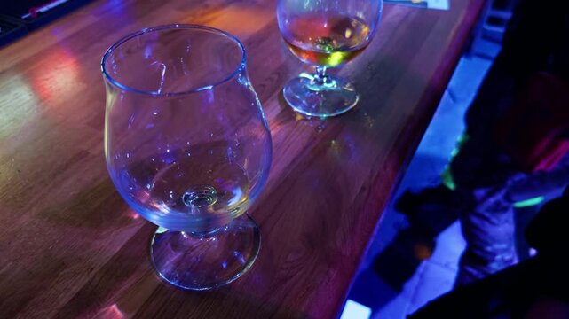 Lonely bar environment where glasses are untouched and ambiance remains silent and peaceful