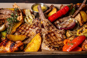 Mixed grilled meat platter with vegetables and lamb chops