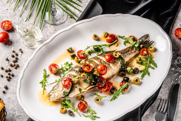 Whole roasted fish with olives and cherry tomatoes
