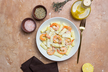 Pasta in a creamy sauce with shrimp and cheese. Seafood. Italian cuisine.