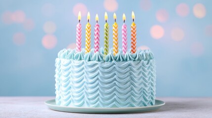 A light blue frosted cake with wavy ribbed sides sits on a gray cake board,