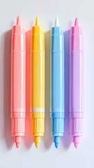 Four colorful highlighters lay on white paper