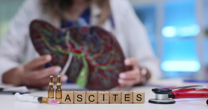 Wooden blocks spell word Ascites against liver model and ampoules. Hepatology doctor studies ascites case planning fluid drainage procedure in lab