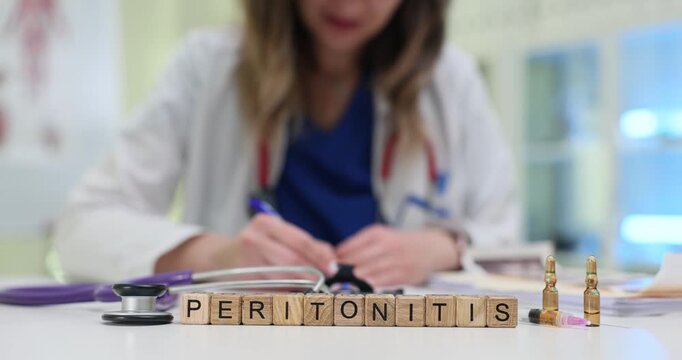 Wooden blocks spell word Peritonitis near stethoscope and ampoules on table. Medical woman writes report prescribing treatment for peritonitis