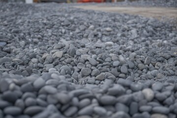 Close up of smooth gray gravel stones on construction site rocks pebbles