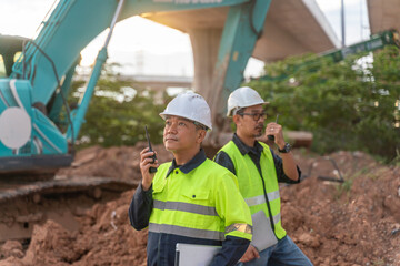Construction supervisors communicating on site urban development photography daylight close-up teamwork