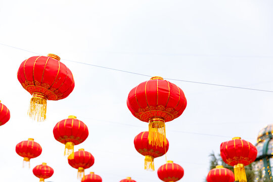 Red paper Chinese lanterns hanging on Chinese New year festival on white sky background. Copy space. High quality photo.