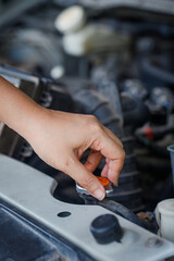 Close up of a hand of woman is checking a liquid coolant pot