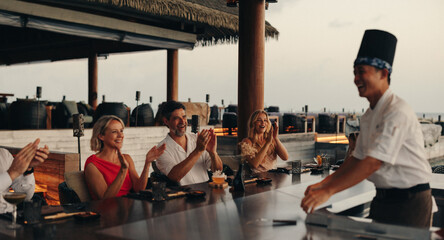 Group of friends enjoying a teppanyaki dining experience at a luxury restaurant