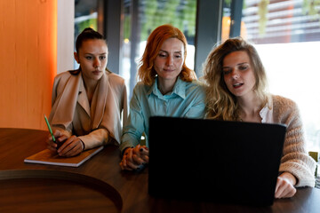 Businesswoman collaborating in a modern workspace with colleagues during a productive team meeting focused on strategy development