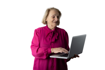 Senior woman smiling and using laptop learning technology