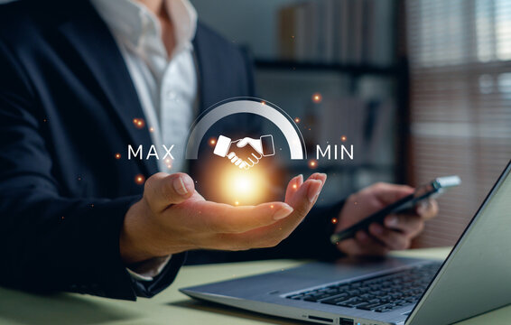 Business partnership concept with a professional holding a digital handshake gauge from minimum to maximum, symbolizing collaboration strength, trustworthy cooperation, strategic relationship growth.