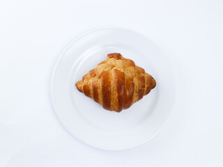 croissant on white plate isolated on white background