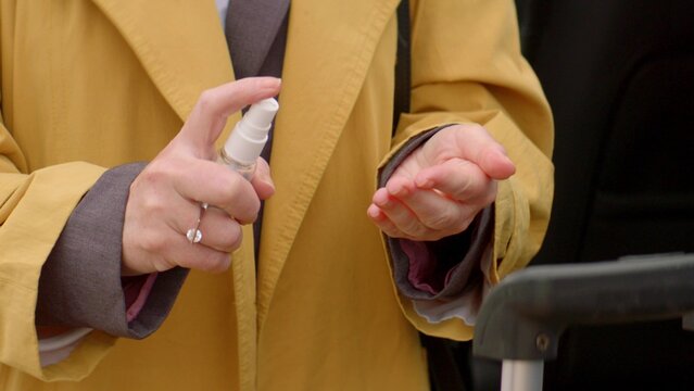 Close up woman hands disinfecting by spray