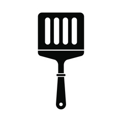 Black silhouette of a slotted spatula on white kitchen