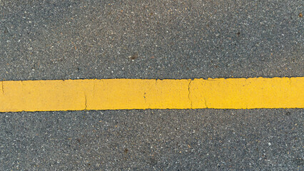 Fototapeta premium Top view of asphalt road with one yellow line.