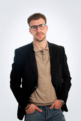 Confident young businessman standing against isolated white background