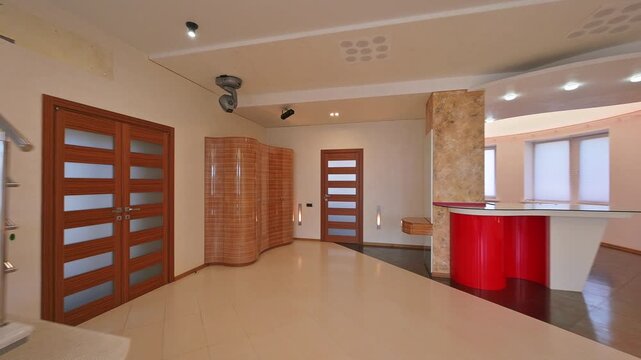Bright interior with modern spiral staircase, stone-clad column, and minimalist furniture. Clean lines, neutral tones, and accent lighting create a spacious and sophisticated ambiance
