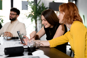 Fototapeta premium Business meeting in a modern office with team members collaborating on a project, discussing ideas, and sharing insights during the day