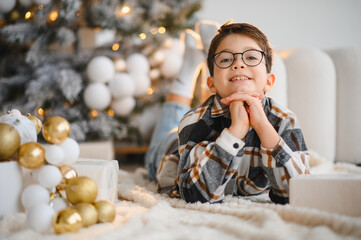 Happy boy celebrating christmas holiday at home