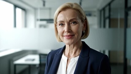 Portrait of a hopeful, smiling mature businesswoman in a modern office - Powered by Adobe