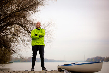 Confident senior man standing outdoor in an autumn day