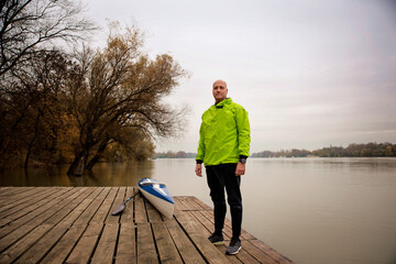 Confident senior man standing outdoor in an autumn day