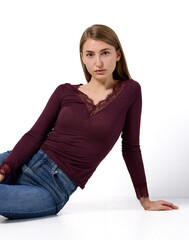 Slavic woman in lace top posing on floor