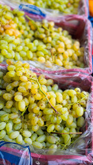 bunches of fresh white grapes in a box at a local farmers' market, Greece