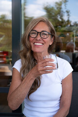 Portrait of a senior woman drinking healthy water and smile. 