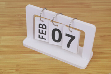 February, 7 on calendar on wooden table close-up.	