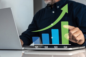Businessman analyzing financial growth and performance on a futuristic virtual bar chart