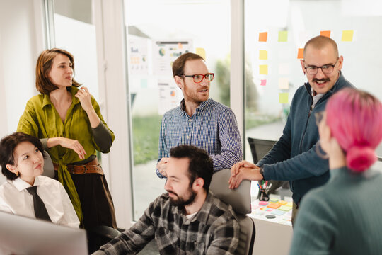Business professionals engaged in collaborative discussion in a modern office setting during the afternoon