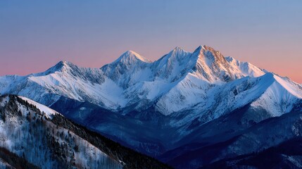 Breathtaking view of snow-covered mountains during sunrise, showcasing natural beauty and tranquility in a serene landscape.
