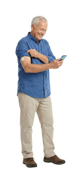 Senior man monitoring glucose levels with smartphone arm sensor