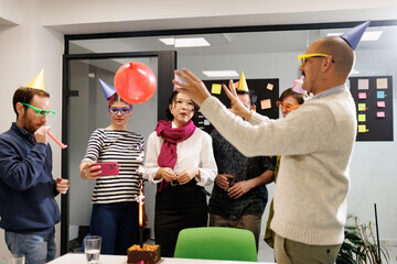 Business celebration with colleagues enjoying a fun party atmosphere with colorful decorations and activities in a vibrant office setting