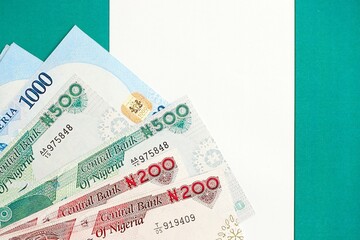 Nigerian naira currency money bills lies on flag close up. The concept of business and investment