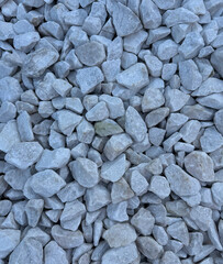Pattern of white gravel with a uniform, clean texture. Сlose-up view of small, smooth gravel stones arranged in a seamless, repeating design. Ideal for backgrounds, surfaces, and abstract designs.