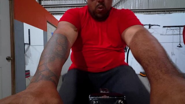 UGC-style video shot from a low POV showing a person exercising at the gym. 