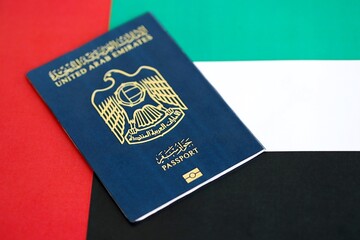 United Arab Emirates passport on flag close up. The concept of citizenship