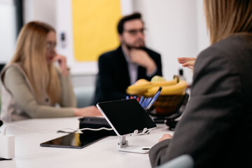 Team discussing ideas during a meeting with a focus on collaboration and technology