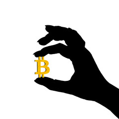 silhouette of the hand holding a golden symbol of Bitcoin