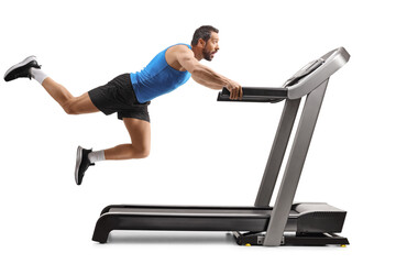 Strong man falling from a treadmill with legs in the air