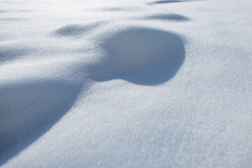 Close-up of pure white snow surface. Bumpy texture with soft shadows, perfect for winter, Christmas, and nature backgrounds. Winter and snow texture