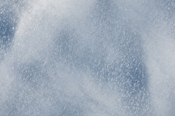 Macro view of frozen snow surface. Abstract winter background with white and light blue ice crystals, ideal for seasonal wallpapers and holiday cards. Snow holidays winter background.