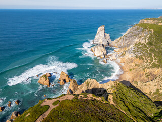 Cabo da Roca, Ursa Beach, Sea Stacks, Cliffs, Green Mountains and Atlantic Ocean on Sunny Day from Above. Aerial View. Portugal