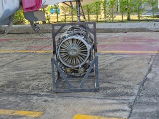 An aircraft jet engine mounted in a maintenance stand