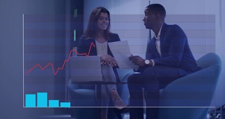 Reviewing financial chart pair discussing documents in office, in suits with laptop and overlay