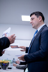Business executive in a suit discussing documents during a meeting