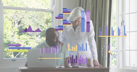 Leaning senior woman wearing blouse checking papers while man using laptop at home with data charts
